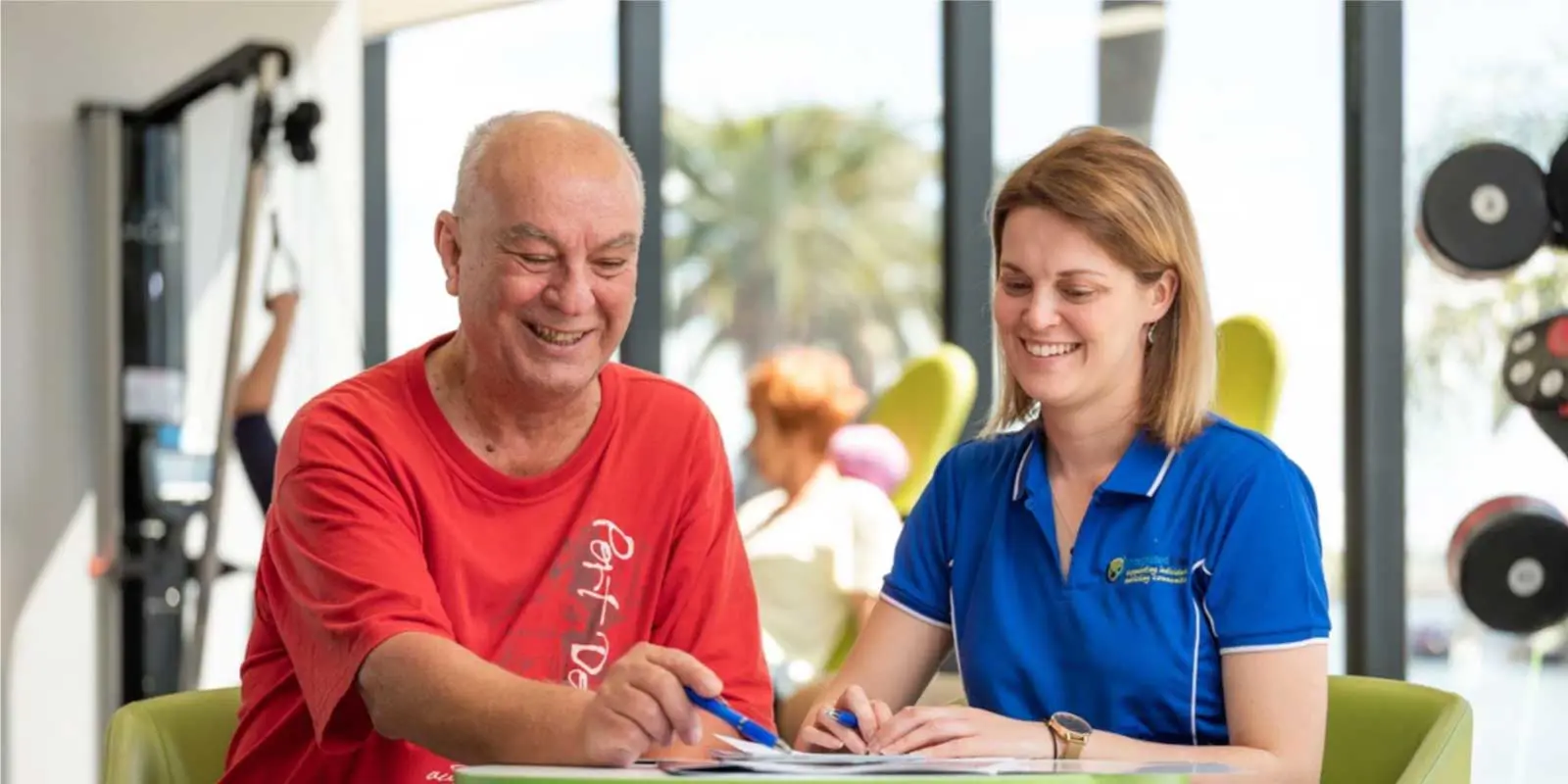 integratedliving social worker assisting male client to read papers